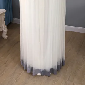Detailed view of a cylindrical floor-standing air conditioner cover with white sheer and hem.
