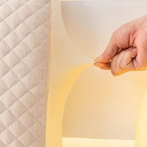 Close-up detail of stretchable quilted headboard cover showing soft fabric elasticity.