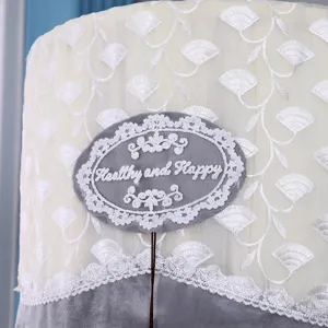 Detailed view of cylinder air conditioner cover with white ginkgo embroidery and lace badge.