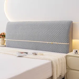 Grey quilted bed headboard cover detail, soft protective dustproof fabric design.