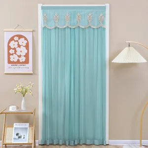 Sheer door curtain with elegant lace valance in soft teal color, creating a cozy room partition.