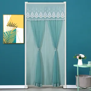 Elegant teal door curtain with delicate lace embroidery and pom-pom fringe for home decor.