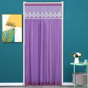 Purple mesh door curtain hanging in room scene, featuring white lace and pompom trim details.