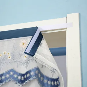 Detail view of Velcro lace mosquito door curtain with blue velvet and white daisy embroidery.