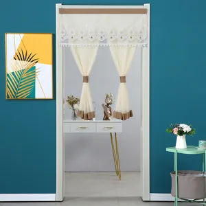 Chic beige mesh door curtain with delicate lace embroidery and tassels, ideal for room division.