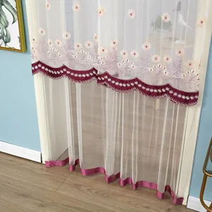 Detailed view of sheer mesh door curtain with floral embroidery and burgundy scalloped border.