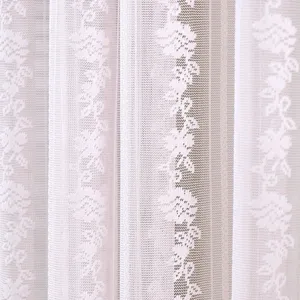 White lace sheer curtain detail closeup, delicate floral pattern for privacy and home decoration.