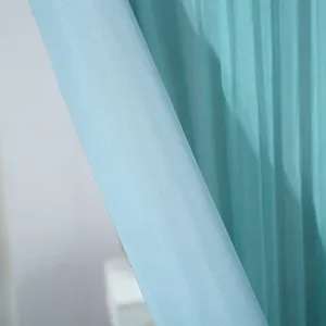 Light blue sheer curtain fabric detail, soft texture and pleated design for home decor.
