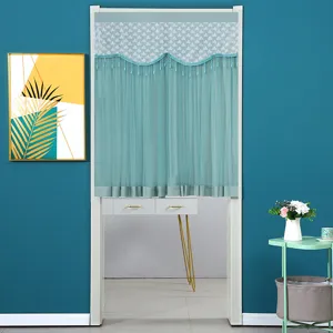 Detailed view of the turquoise lace door curtain, featuring elegant fringe tassels and sheer fabric.
