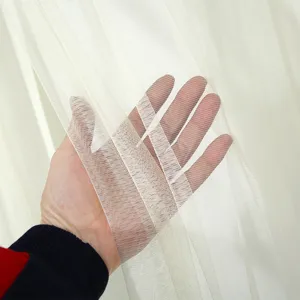 Close-up detail shot of the sheer curtain fabric, showcasing soft texture and light transmittance.
