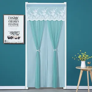 Turquoise door curtain with white lace trim and bow tiebacks for bedroom privacy and decor.