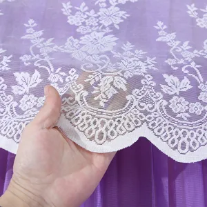 White floral lace curtain detail, delicate mesh fabric with elegant scalloped edge design.