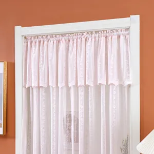Detail view of pink lace short curtain, sheer gauze fabric with floral lace design.