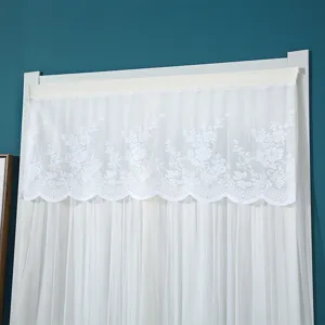 White lace short curtain with floral embroidery and wavy hem, elegant home decor detail.