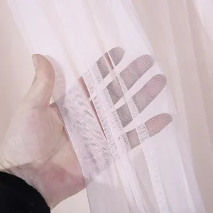 Close-up view of light pink mesh fabric curtain texture, lightweight and breathable material.