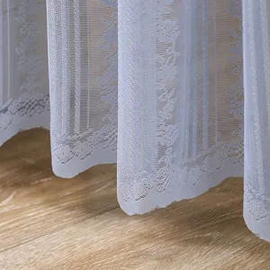 Detailed view of light blue lace curtain with delicate floral patterns and soft drape texture.