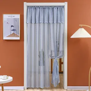 Detailed shot of the blue sheer lace door curtain hanging in a cozy home interior setting.