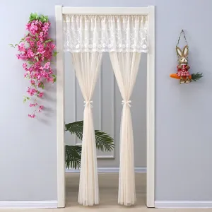 Close-up of beige lace door curtain, sheer mesh fabric, elegant room partition detail.