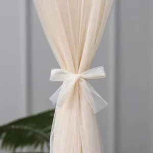 Beige sheer lace door curtain detail, elegant bow tie design, ideal for bedroom partition.