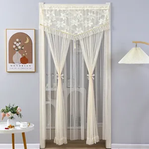 Detailed view of elegant ivory lace door curtain with floral embroidery and lovely tiebacks.