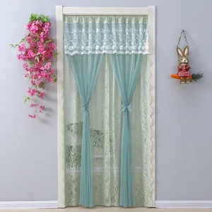 Detail view of green lace door curtain with delicate embroidery and sheer fabric for room partition.
