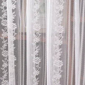 Detailed view of white lace fabric with floral pattern and vertical stripes for home decor.