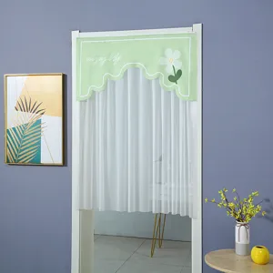Half door curtain with green scalloped top, white floral pattern and sheer bottom layer.