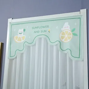 Detail view of the light green fabric short door curtain featuring cute lemon and animal prints.
