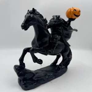 Close-up of black resin Headless Horseman figurine holding an orange jack-o-lantern