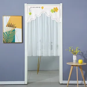 Punch-free sheer fabric half door curtain with yellow floral design hanging in doorway view