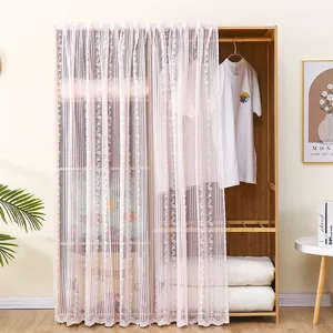 Pink lace dust curtain detail showing delicate floral embroidery and sheer mesh fabric texture.