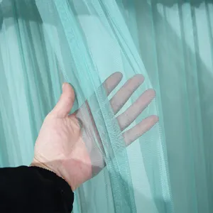 Detailed close-up of light green mesh curtain fabric showing fine texture and light transparency.