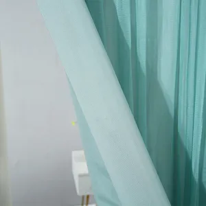 Detailed view of teal door curtain fabric showing fine texture and soft drape effect.