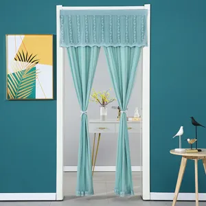 Detail view of green lace sheer door curtain, elegant room divider for home privacy and decor.