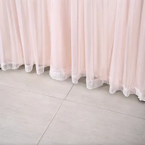 Close-up detail of soft pink sheer door curtain with delicate lace hem trim for bedroom.