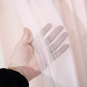 Detailed view of soft pink sheer curtain fabric, breathable mesh texture showing light transmission.