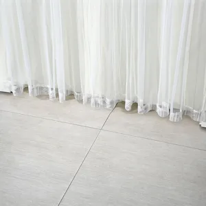 Elegant white sheer door curtain lace hem detail close up indoor home decor display