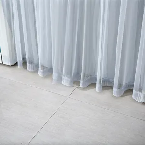 Grey sheer door curtain detail, lightweight mesh fabric with delicate hem, modern home decor.