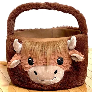 Soft brown plush highland cow Easter basket with cute embroidered face for egg hunting
