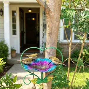 Detailed macro of a heart-shaped floral bird feeder hanging in a lush garden tree