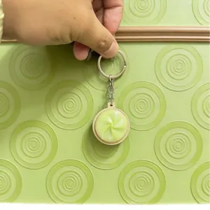 Portachiavi creativo a forma di panino al vapore verde chiaro con trama a spirale