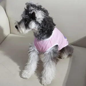 Close-up detail of a small dog wearing a cute pink summer pet vest, comfortable and breathable.