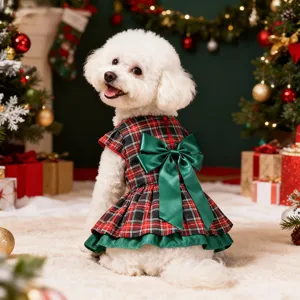 Detailed view of the Christmas plaid pet dress with a large green bow and festive holiday background.