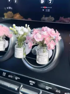 Car air vent perfume clip with mini glass bottle and cute artificial baby breath flowers decor.
