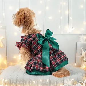 Cute Christmas plaid dog dress with a large green bow, perfect for holiday pet styling detail.