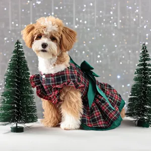 Cute Christmas plaid dog dress with green bow and ruffles, perfect for pet holiday party.