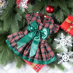 Cute Christmas plaid dog dress with green bow, perfect holiday pet apparel for festive photos.