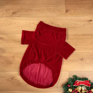 Red velvet pet Christmas clothes detail, comfortable dog holiday apparel close-up.