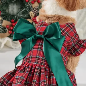 Festive red plaid dog dress featuring a big green satin bow for Christmas holiday pet wear.