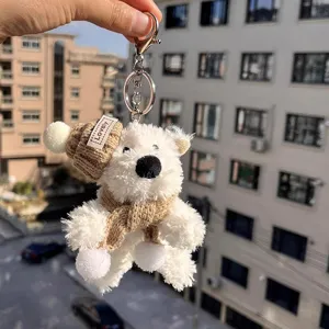 Cute fluffy white bear plush keychain with knitted hat and scarf, soft bag charm accessory.